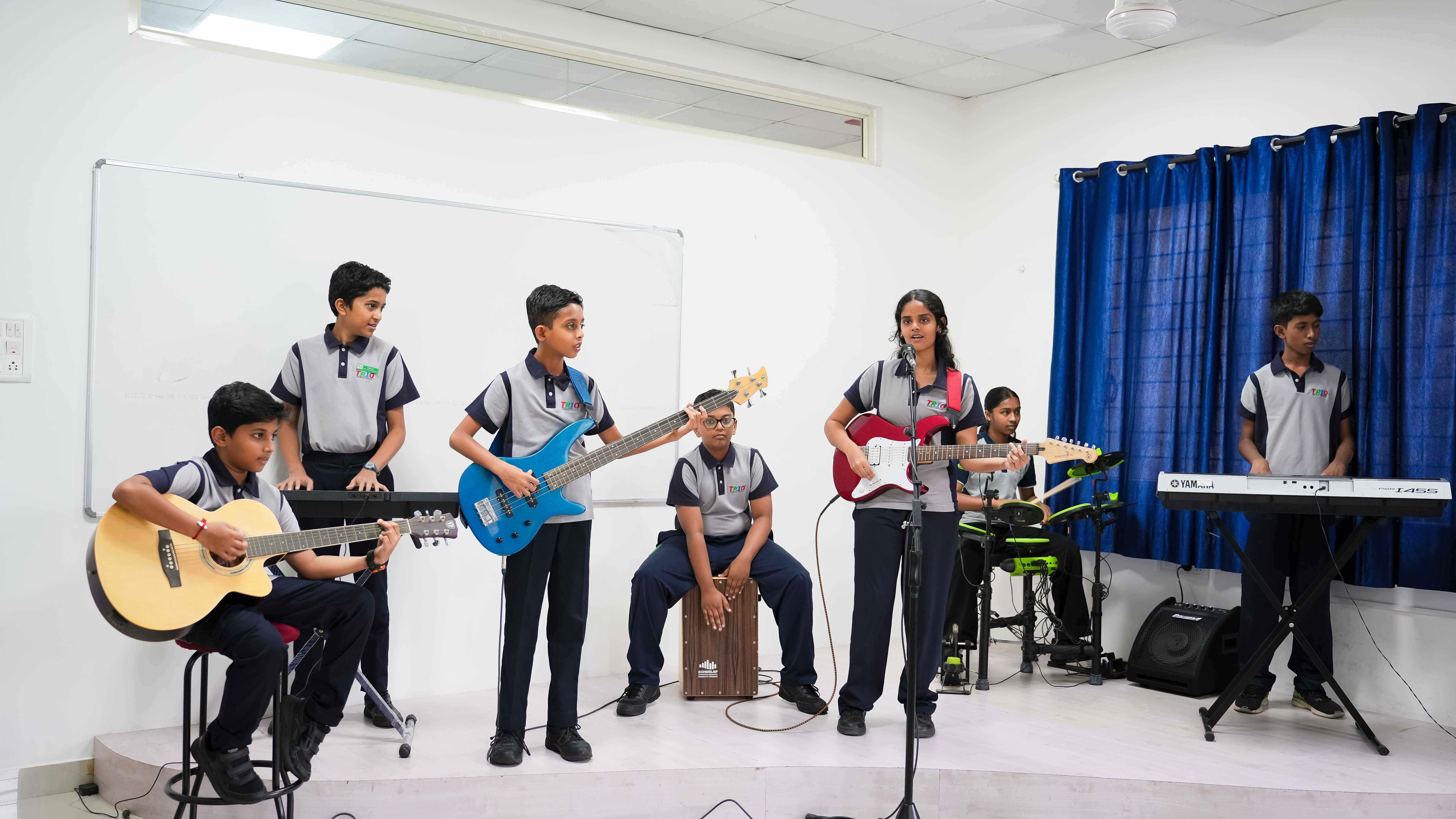 Students creating artwork with paints and various craft materials